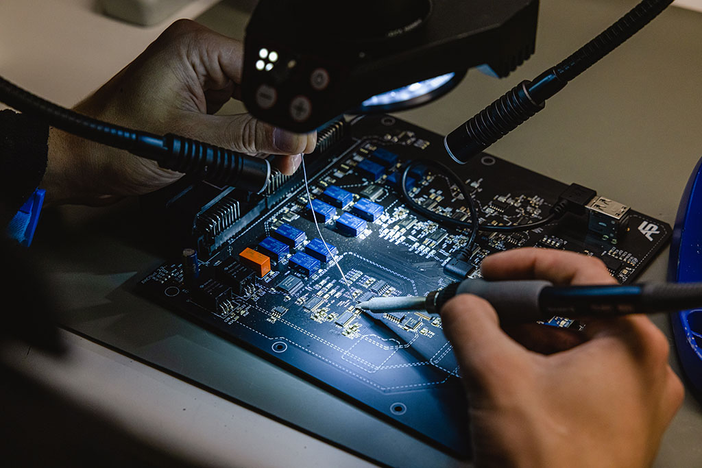 Close up view of a circuit board being worked on