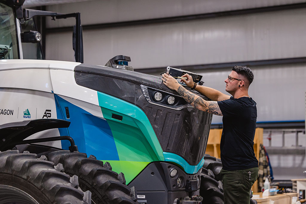 A man working on the front of a tractor