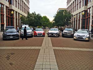 Six vehicles arranged in a row on a street