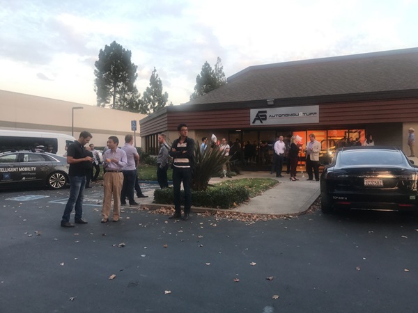 People standing outside in a parking lot