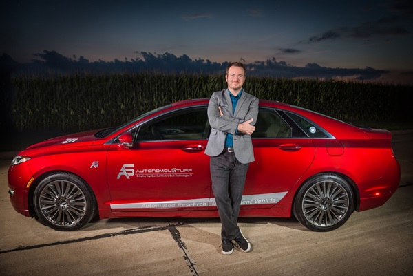 Man standing in front of a red car