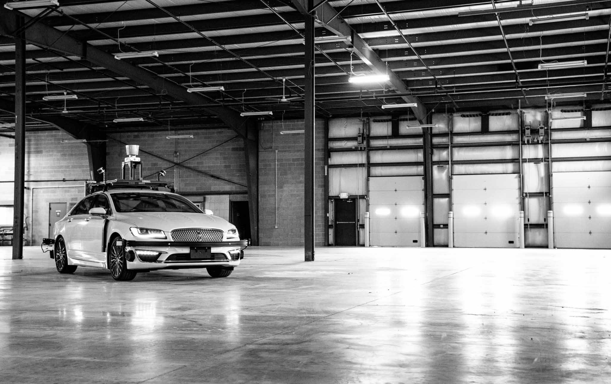 Black and white photo of vehicle inside a shop