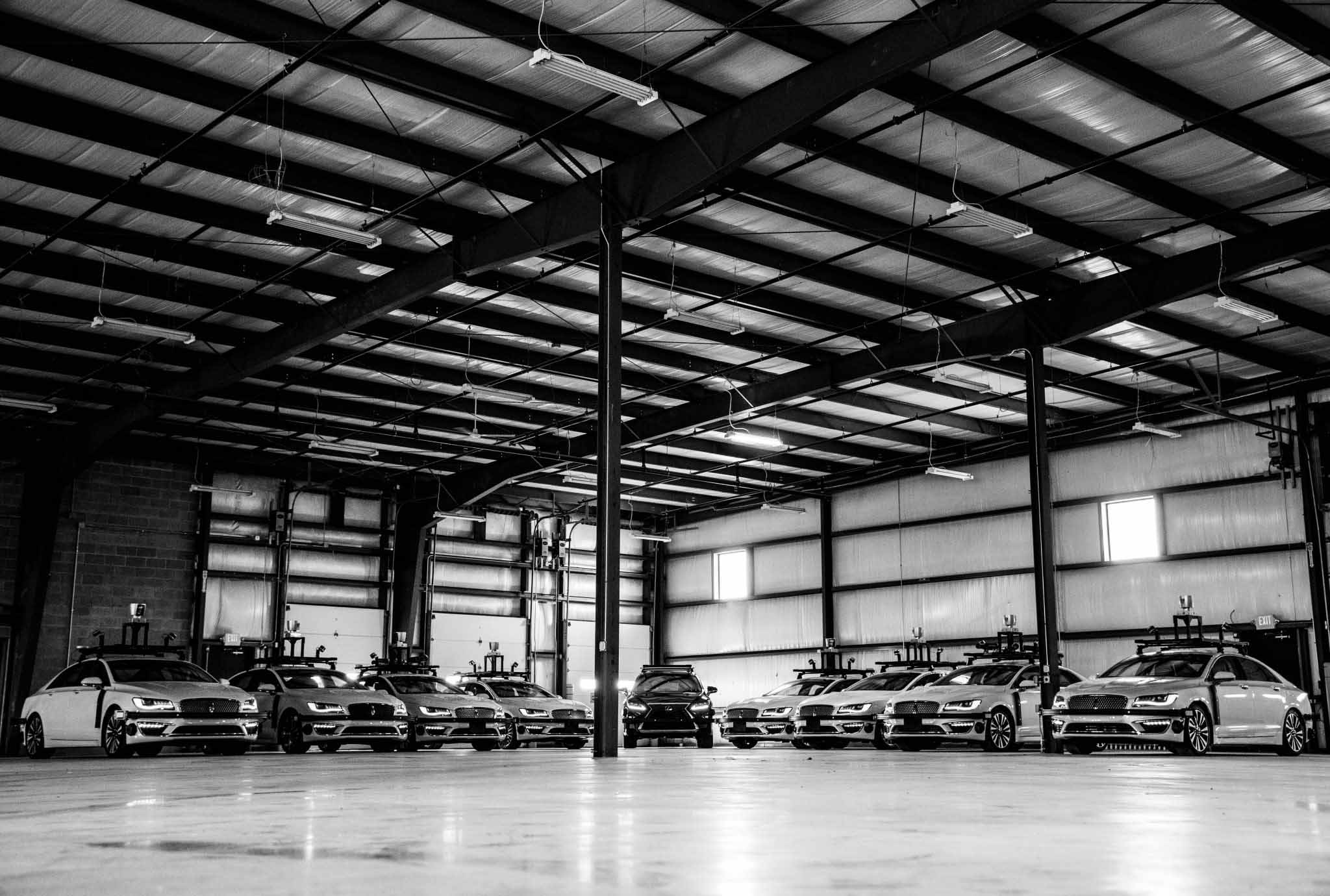 Wide shot of vehicles in a shop