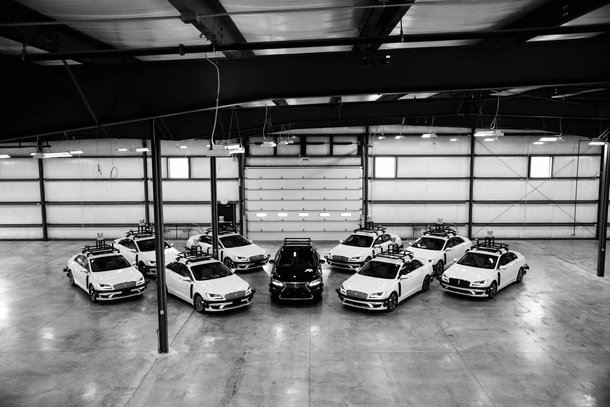 Birds eye view of several vehicles inside a shop