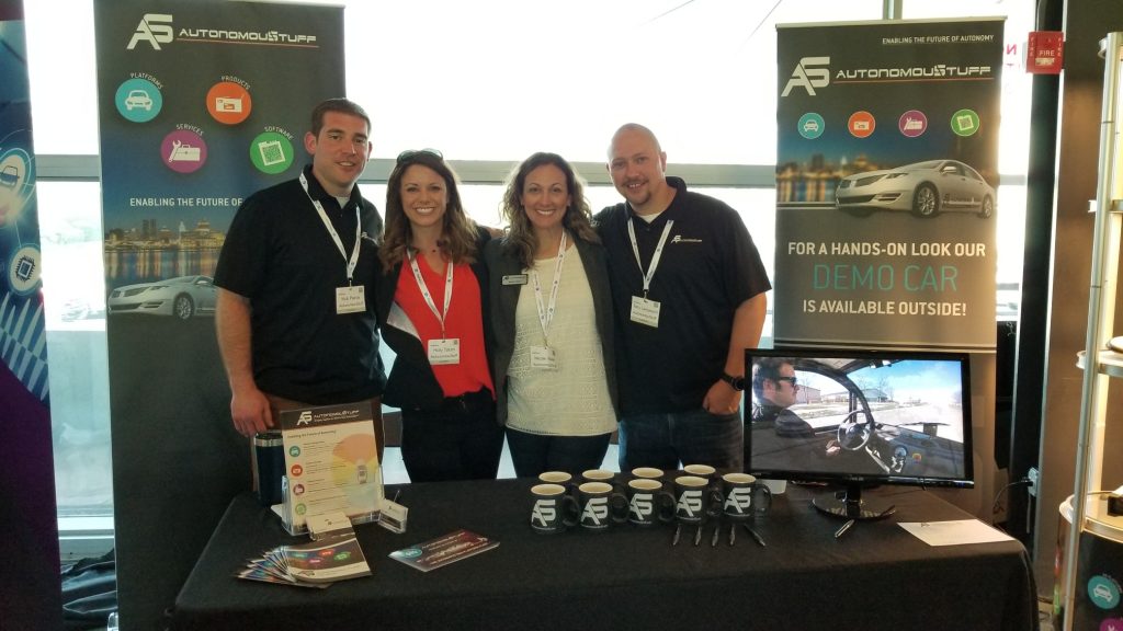 Four people standing behind a display