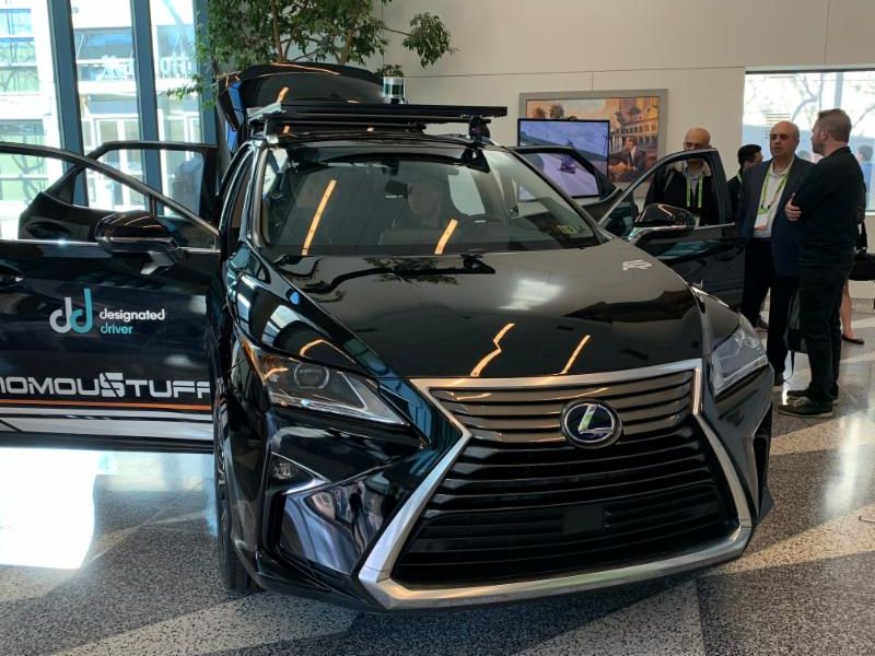 Black Lexus inside a showroom with doors open