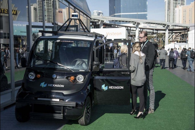 People standing next to a Polaris GEM with doors open