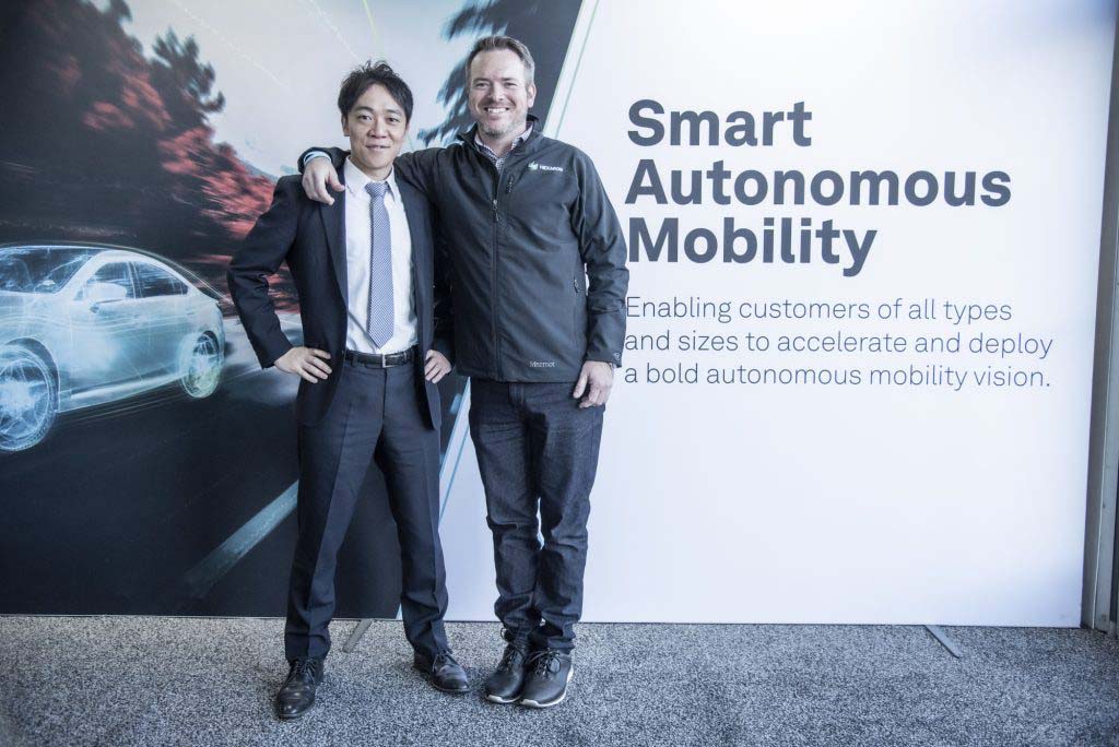 Two men standing in front of a display