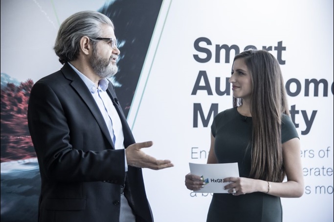 Man and woman presenting in front of a display
