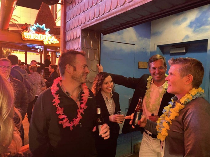Four people standing and talking