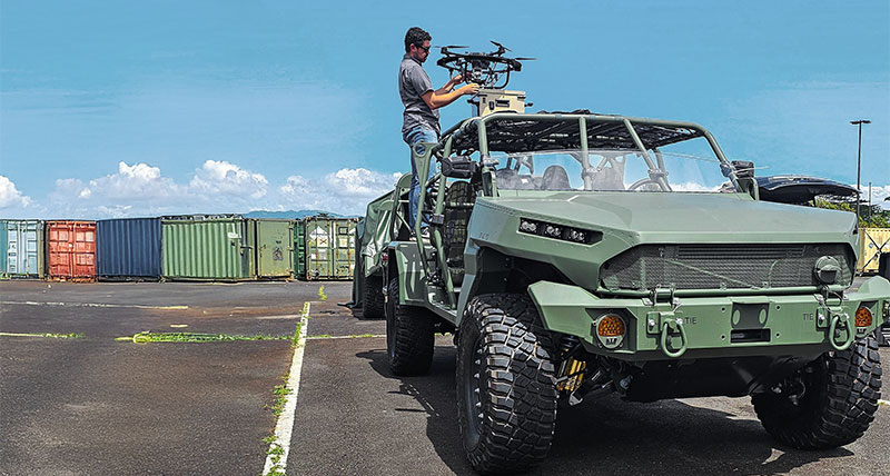 Man setting up Hoverfly tethered unmanned aerial system (TeUAS) on an off-road vehicle.